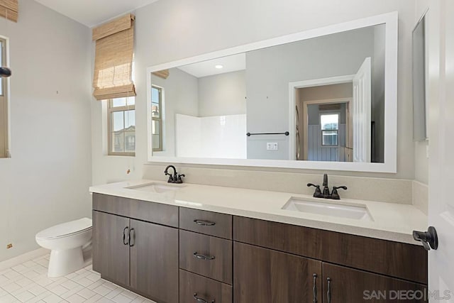 bathroom featuring toilet, tile patterned flooring, and vanity