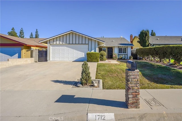 ranch-style house featuring a front yard and a garage