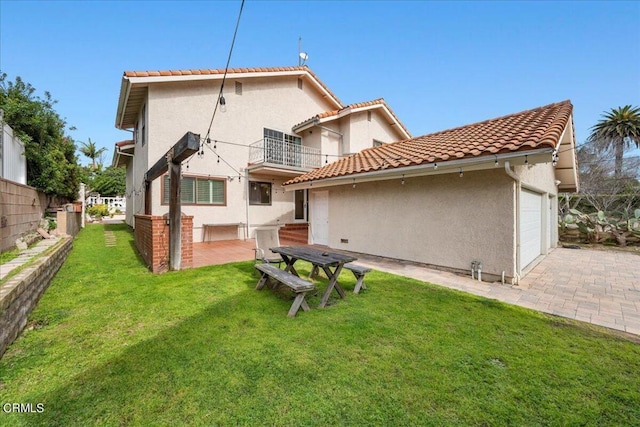 back of property with a balcony and a yard