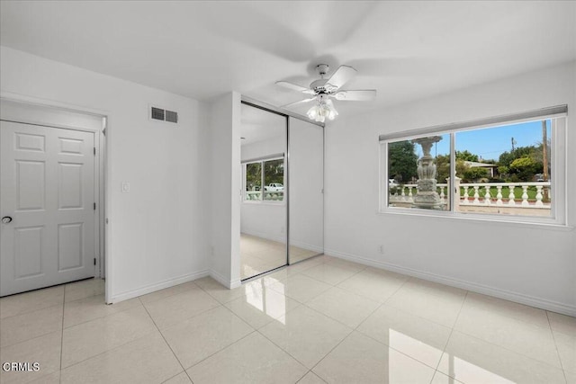 unfurnished bedroom with ceiling fan and light tile patterned floors