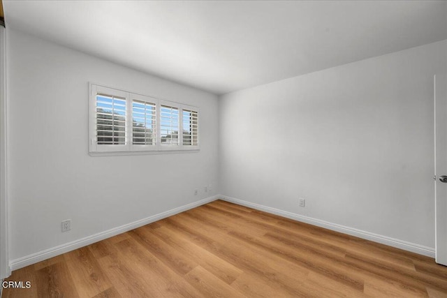 spare room featuring light hardwood / wood-style floors