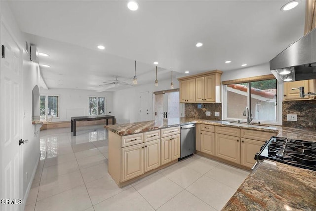 kitchen with kitchen peninsula, dishwasher, dark stone counters, ceiling fan, and sink