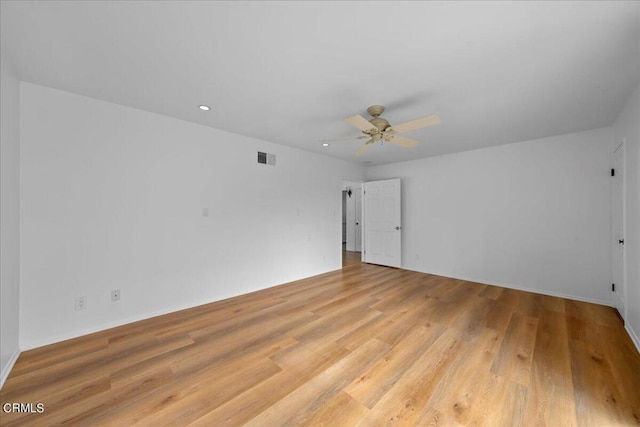 unfurnished room with light wood-type flooring and ceiling fan