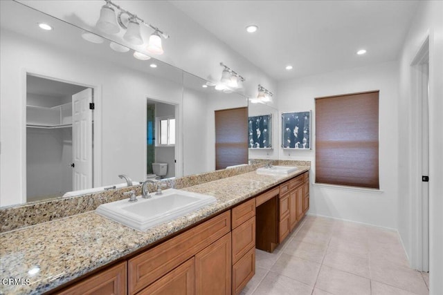 bathroom featuring toilet, vanity, and tile patterned floors