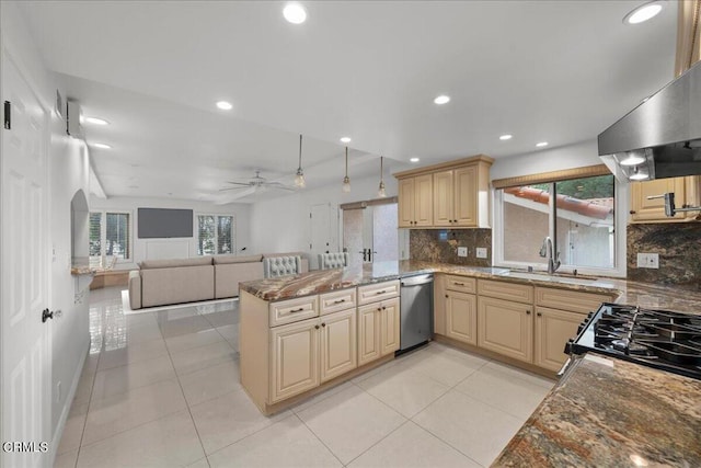 kitchen with dishwasher, dark stone countertops, kitchen peninsula, ceiling fan, and sink