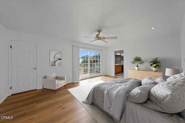 bedroom with ensuite bath, hardwood / wood-style flooring, ceiling fan, and access to outside