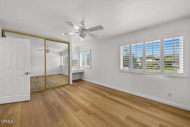 unfurnished bedroom with a closet, ceiling fan, and light hardwood / wood-style floors