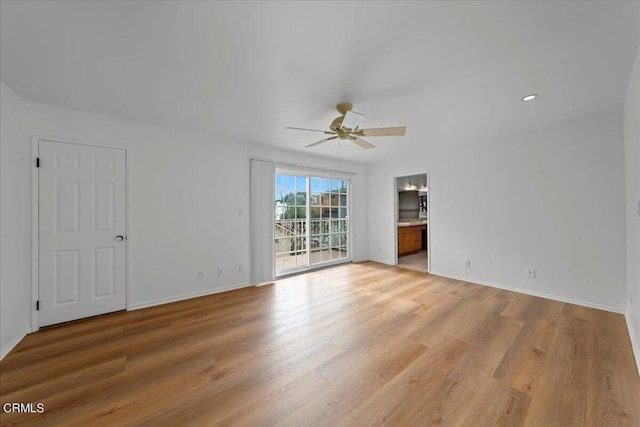 unfurnished room with light wood-type flooring and ceiling fan