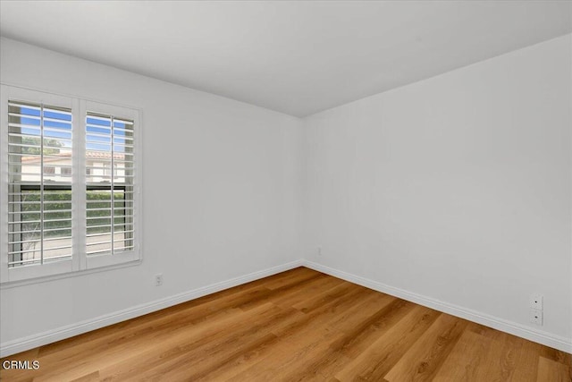 empty room with light hardwood / wood-style flooring