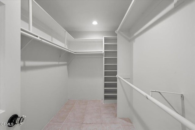 spacious closet featuring light tile patterned flooring