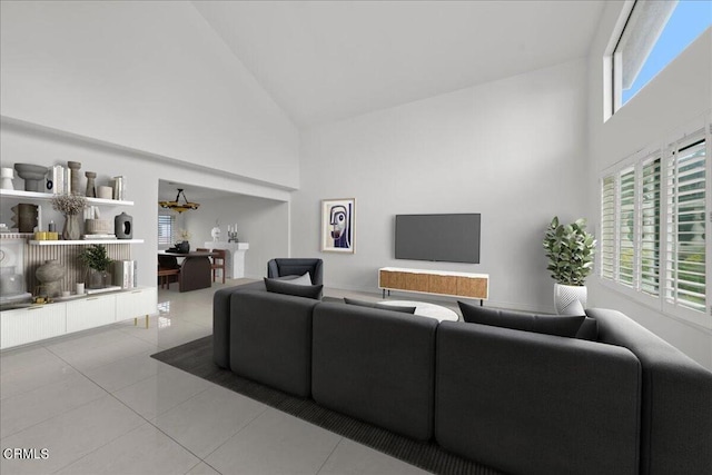 living room featuring high vaulted ceiling and light tile patterned floors