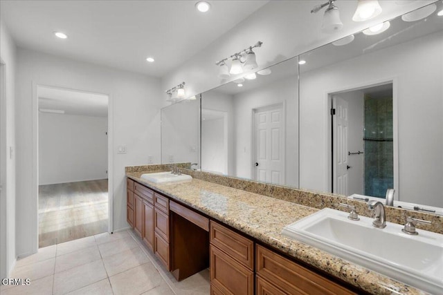 bathroom featuring tile patterned flooring and vanity