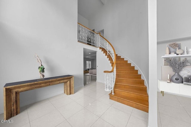 foyer entrance featuring a high ceiling and tile patterned floors