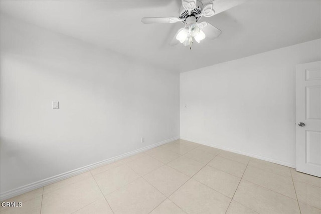 tiled spare room with ceiling fan