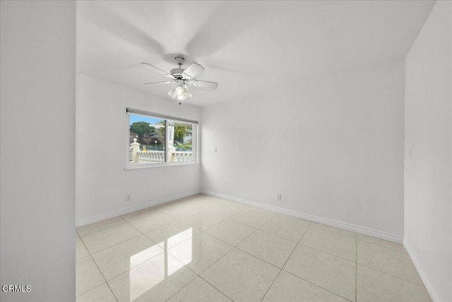 tiled spare room with ceiling fan