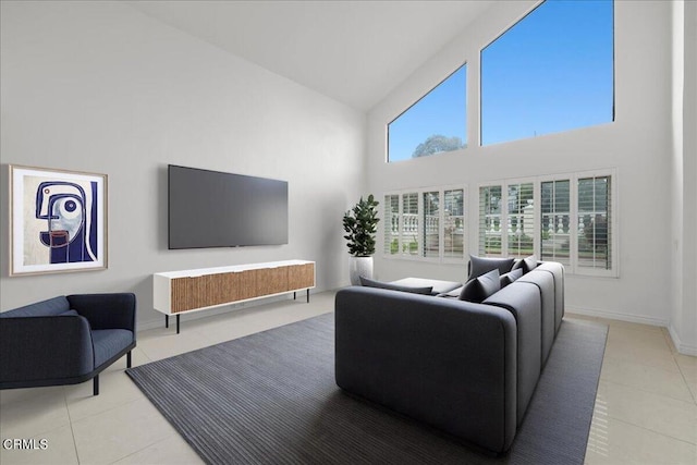 living room with high vaulted ceiling and light tile patterned floors