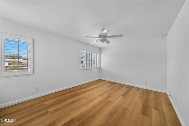 spare room with light wood-type flooring and ceiling fan