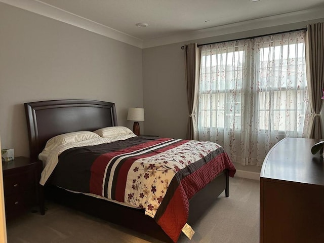 carpeted bedroom featuring crown molding