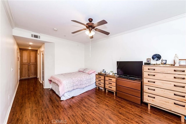 bedroom featuring dark wood-type flooring, ceiling fan, and ornamental molding