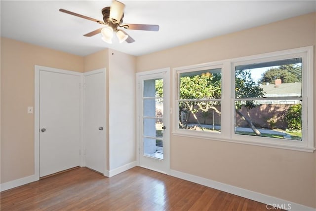 doorway featuring ceiling fan and wood-type flooring