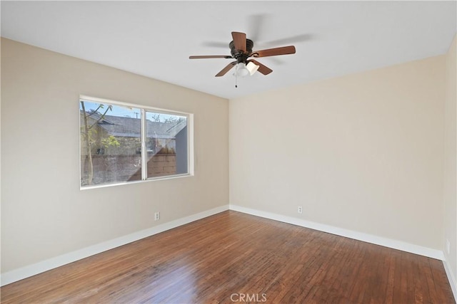 empty room with ceiling fan and wood-type flooring