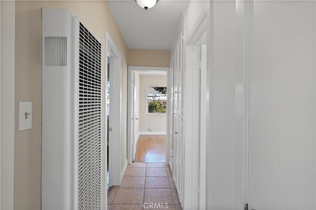 hall with light tile patterned floors