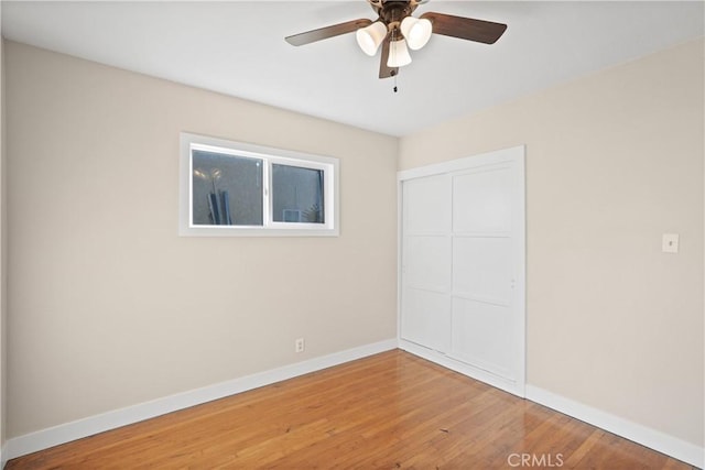 empty room featuring ceiling fan and hardwood / wood-style floors