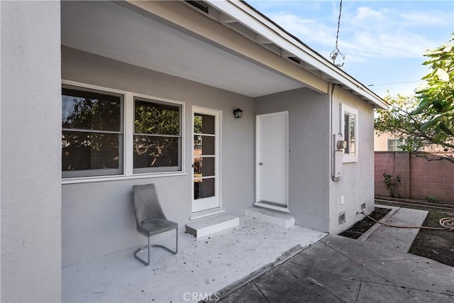 entrance to property featuring a patio