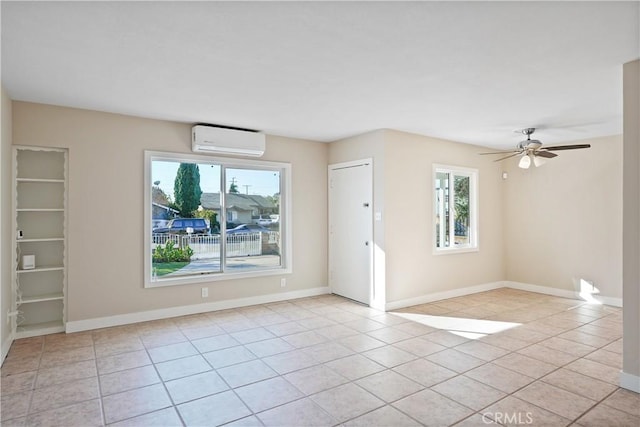 tiled empty room featuring ceiling fan and a wall mounted air conditioner