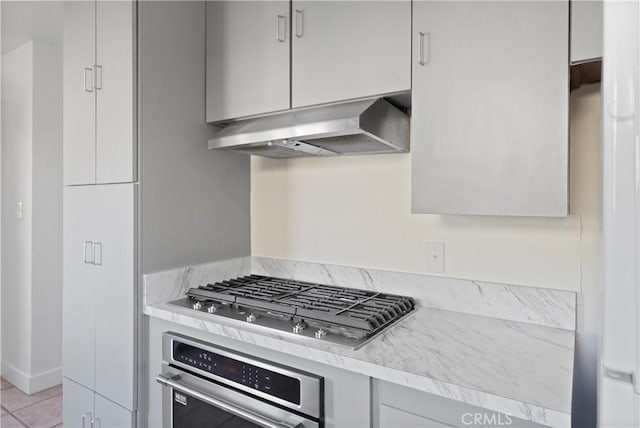 kitchen with stainless steel appliances and light tile patterned floors