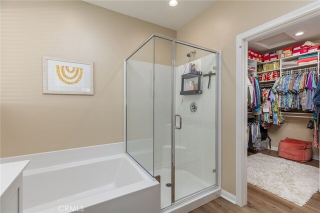 bathroom with hardwood / wood-style flooring and plus walk in shower