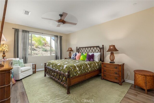 bedroom with ceiling fan and wood-type flooring