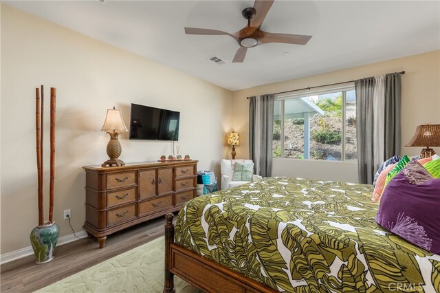 bedroom with wood-type flooring and ceiling fan