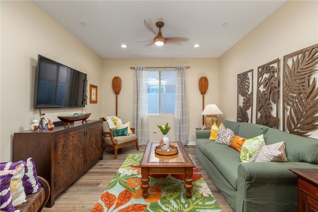 living room featuring light wood-type flooring and ceiling fan