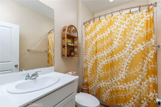 bathroom featuring toilet and vanity