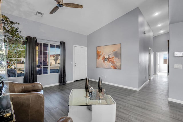 living room featuring high vaulted ceiling, ceiling fan, and dark hardwood / wood-style floors