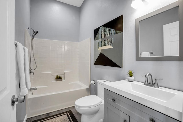 full bathroom with vanity, toilet, hardwood / wood-style flooring, and shower / bath combination