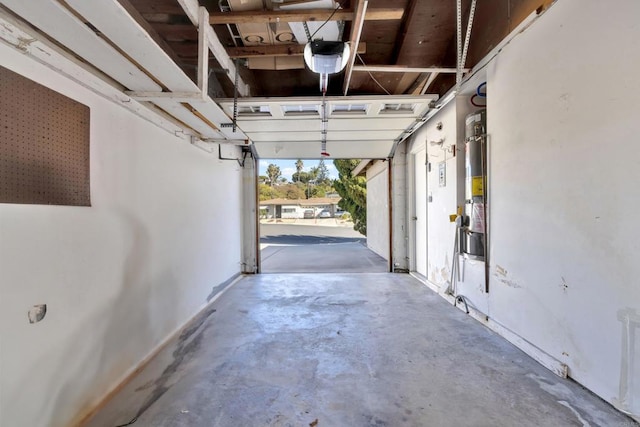 garage with water heater and a garage door opener