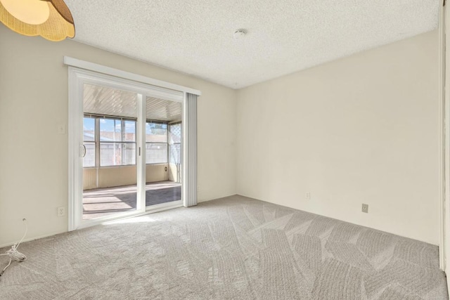 spare room with carpet floors, a textured ceiling, and ceiling fan