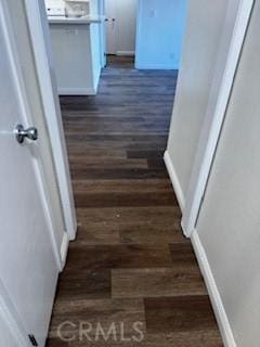 corridor with dark hardwood / wood-style flooring