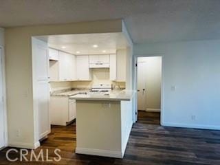 kitchen featuring white cabinetry, stove, dark hardwood / wood-style floors, and kitchen peninsula