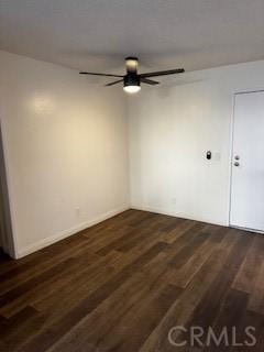 empty room featuring dark wood-type flooring and ceiling fan