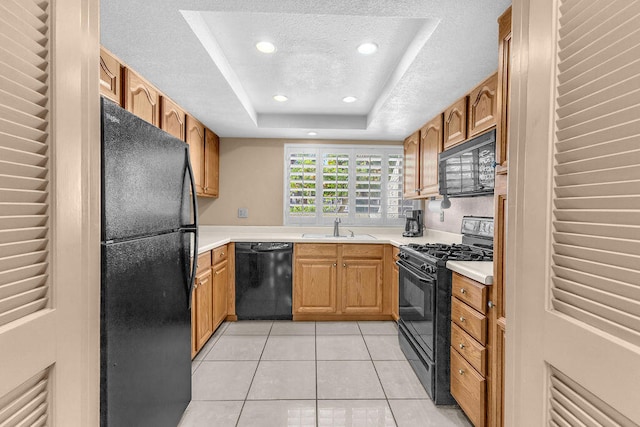 kitchen featuring black appliances, a raised ceiling, sink, a textured ceiling, and light tile patterned floors