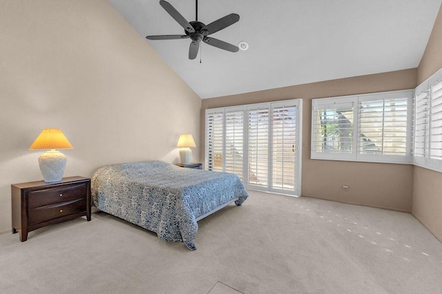 carpeted bedroom with ceiling fan and high vaulted ceiling