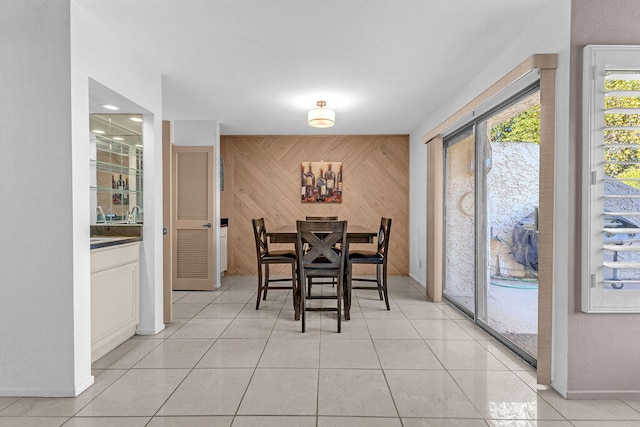 tiled dining room with wood walls