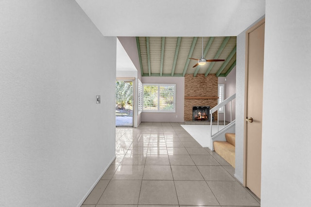 hallway featuring light tile patterned floors and vaulted ceiling with beams