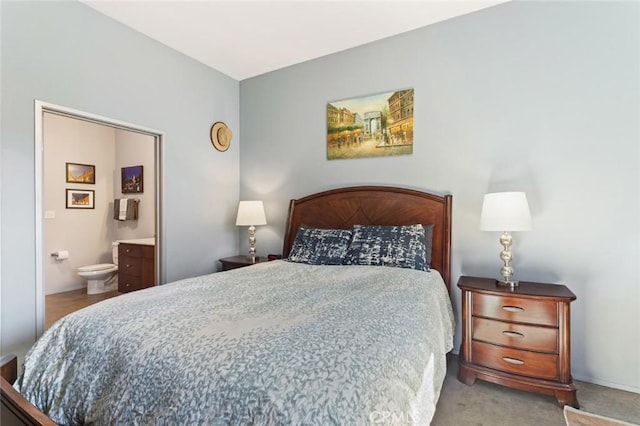 carpeted bedroom with connected bathroom