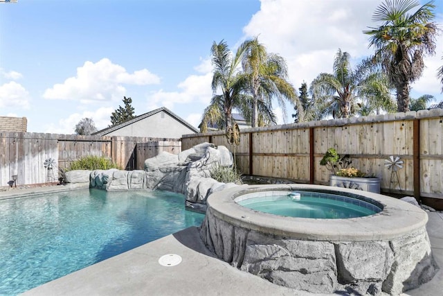 view of pool with pool water feature and an in ground hot tub