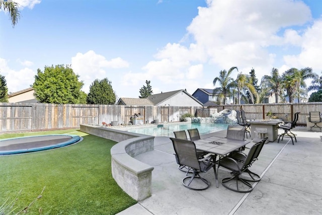 view of patio with a bar and a fenced in pool