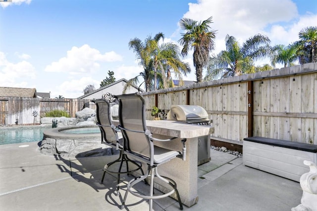 view of patio / terrace with a grill and a swimming pool with hot tub